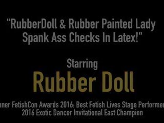 Rubberdoll & Rubber Painted young female Spank Ass Checks in.