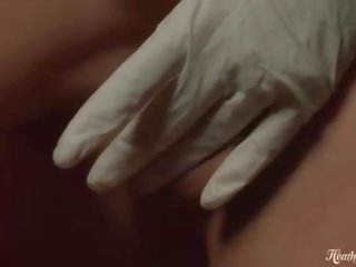 Kink blonde fingers her shaved pussy with gloves on